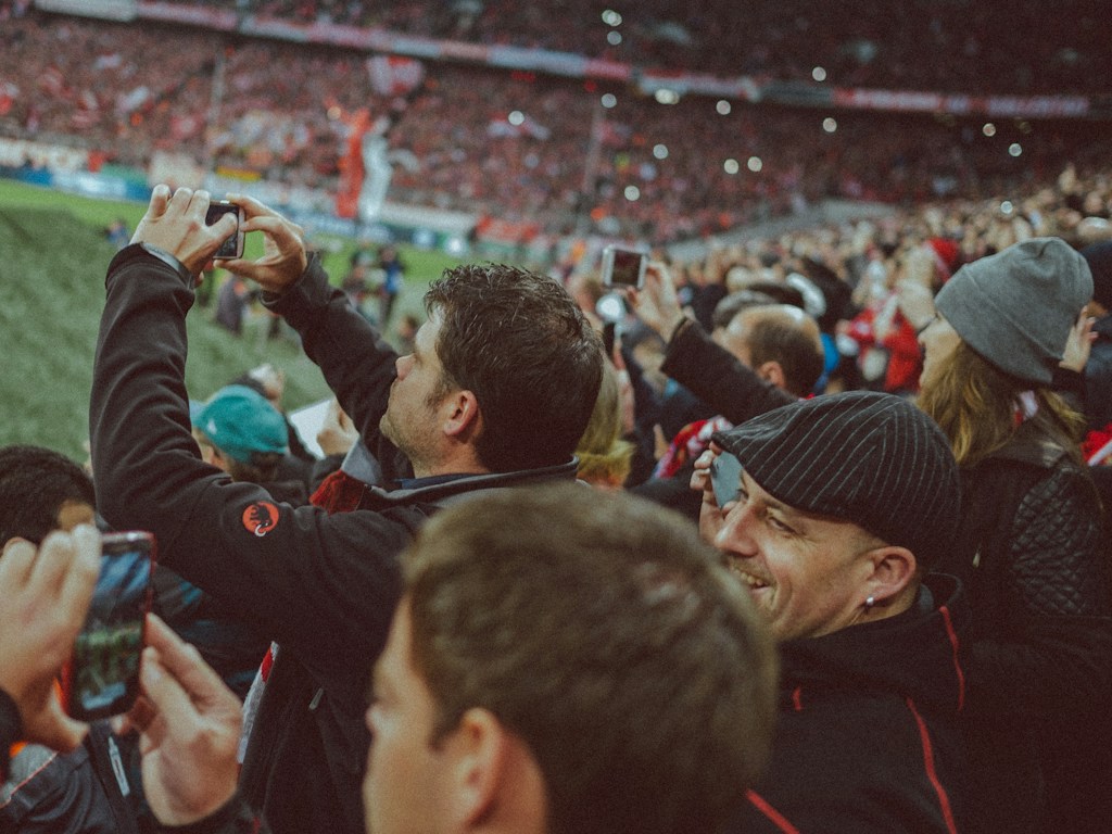 Football supporters watching a match from the stands.