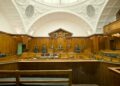 Empty modern courtroom with wooden judicial benches; illustrative image for reporting on a Dubai Court of Appeal judgment.