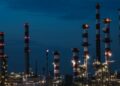 Illustrative view of an oil refinery with processing towers, pipes and industrial infrastructure