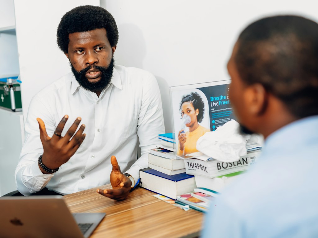 A clinician speaking with a patient in a medical office, illustrating supervised mental healthcare.