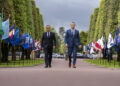French Prime Minister Sébastien Lecornu walking alongside U.S. Defense Secretary Pete Hegseth during a ceremony in Normandy in June 2025.