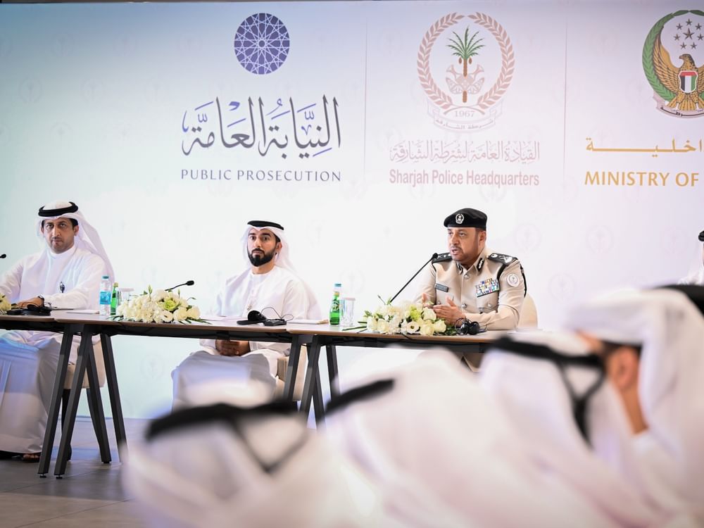Sharjah Police and public prosecution officials at an official media briefing about the cross-border cybercrime operation.