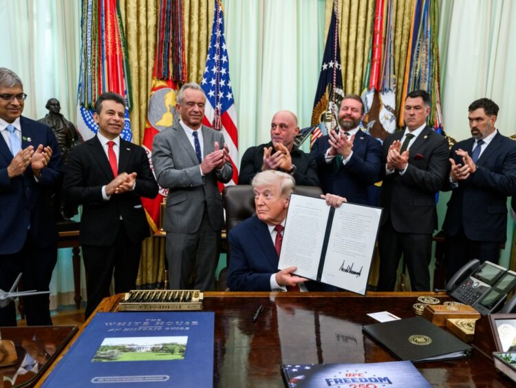 President Donald Trump holds up the signed executive order on accelerating medical treatments for serious mental illness at the White House on April 18, 2026.
